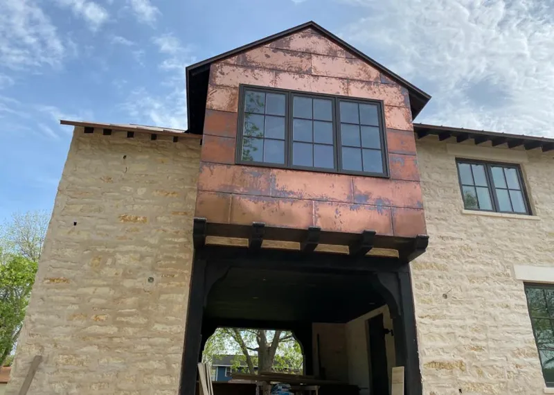 Copper metal panel facade on a stone building for Skylight Installation in Buford